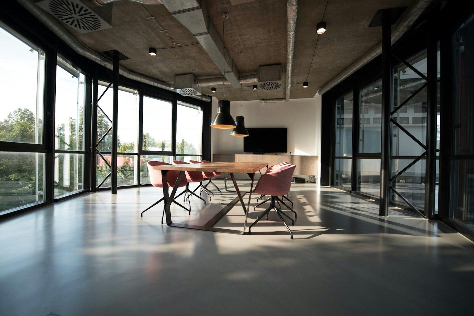 Investor reviewing a private offering memorandum at a conference table with a city skyline in the window