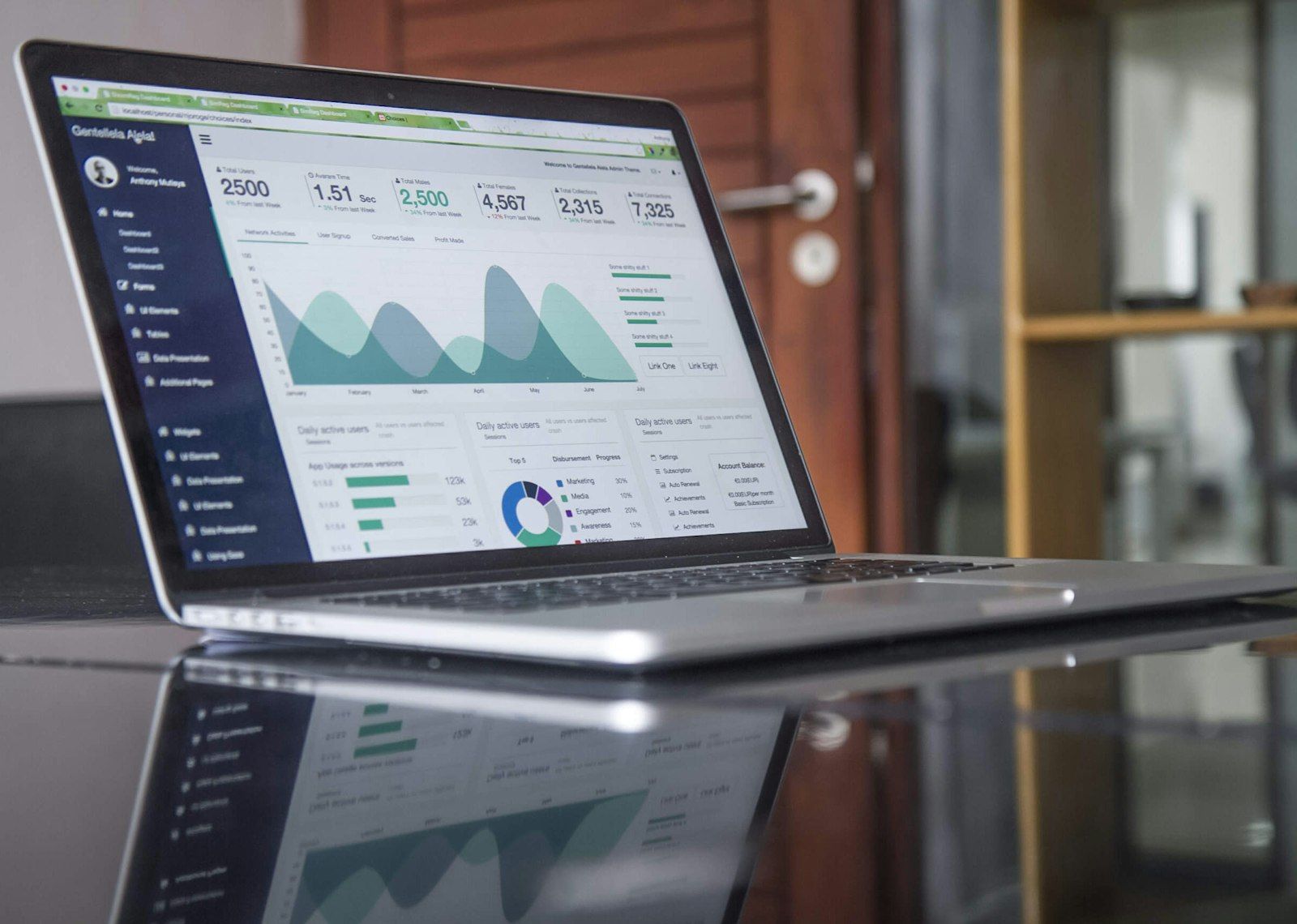 Investor reviewing a rental property spreadsheet on a laptop next to a calculator and printed listing sheets