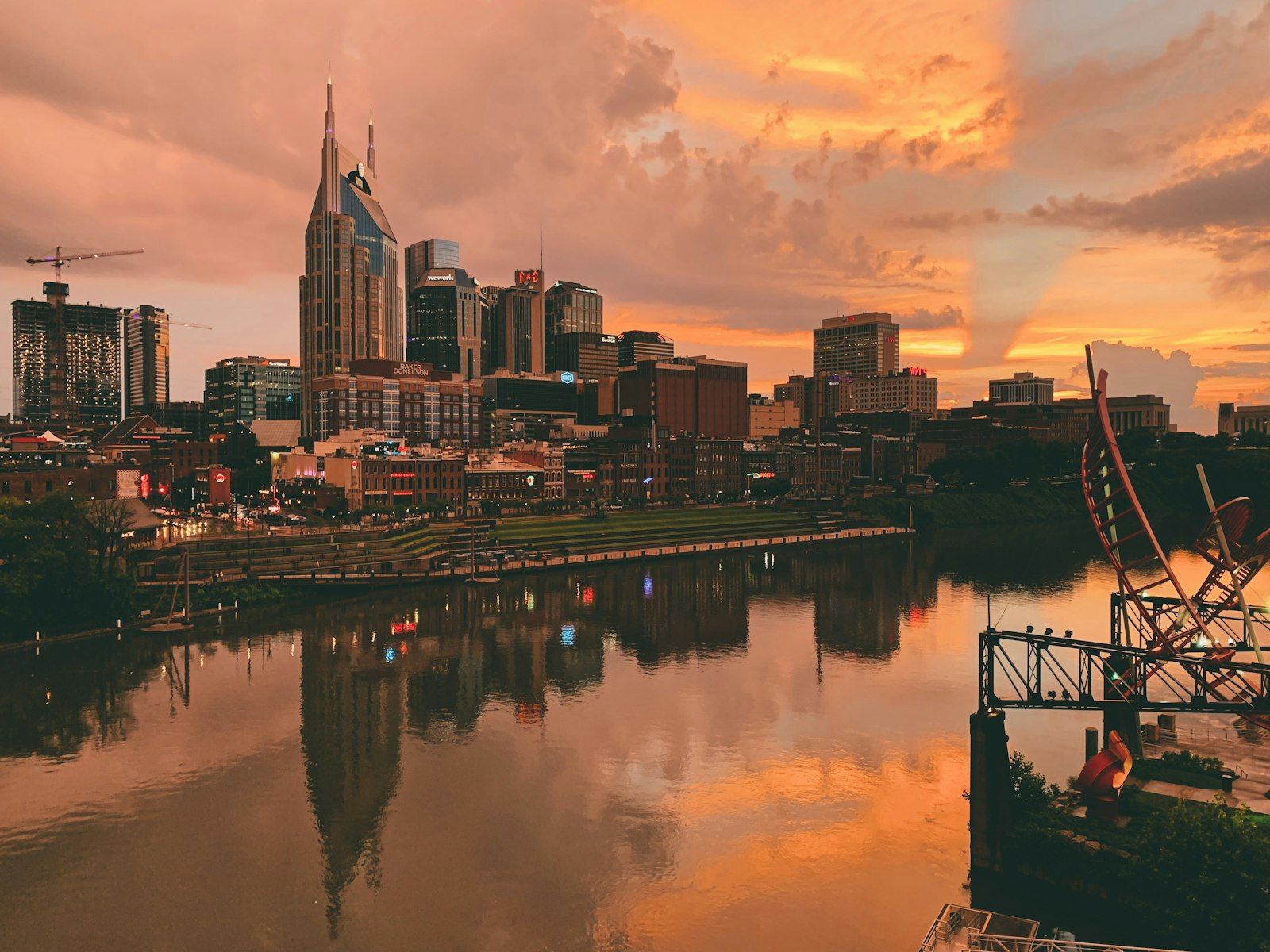 Mid-sized American city downtown with modern towers and a riverfront at dusk